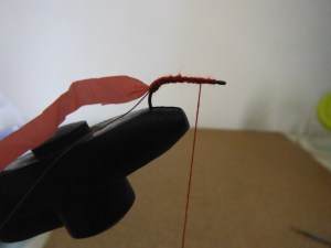 Take the thread back towards the eye