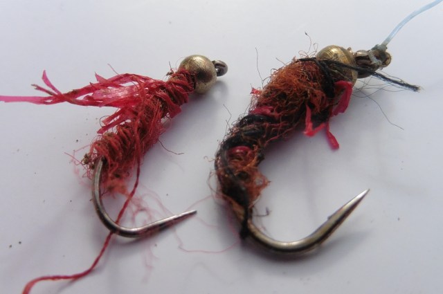 Here is yesterday´s nymph tidied up a bit for the picture alongside the fly that inspired it. The materials give it a hint of life and a kind of "worminess." You may notice the hook has been straightened  a little after a tough scrap with a carp.