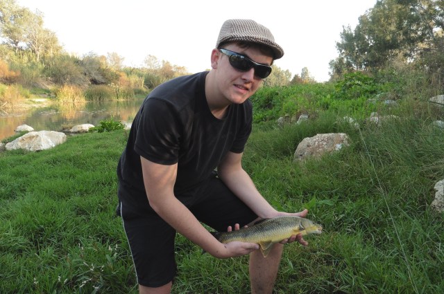 Leo with a barbel that was taken on a little bead head nymph.